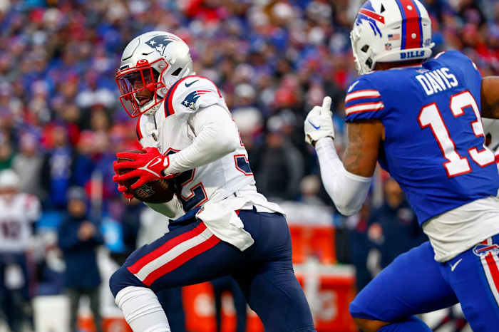 New England Patriots safety Devin McCourty (32) runs back an interception during the first half of an NFL football game against the Buffalo Bills, Sunday, Jan. 8, 2023, in Orchard Park.